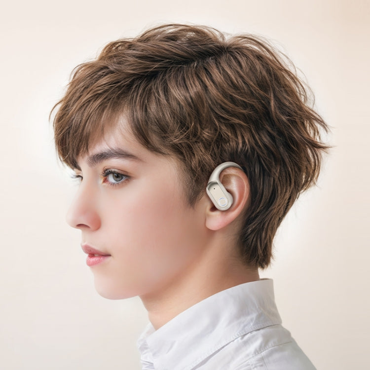 Person wearing a white hearing aid on a plain background